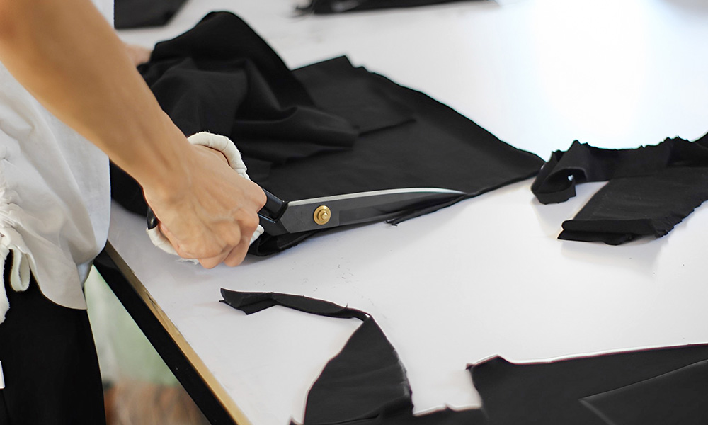 Cutting the fabric pieces by the paper templates.